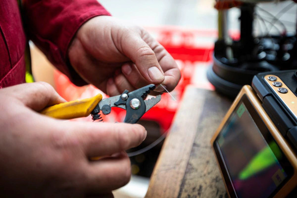 Sure engineer splicing a fibre optic cable Sure engineer splicing a fibre optic cable