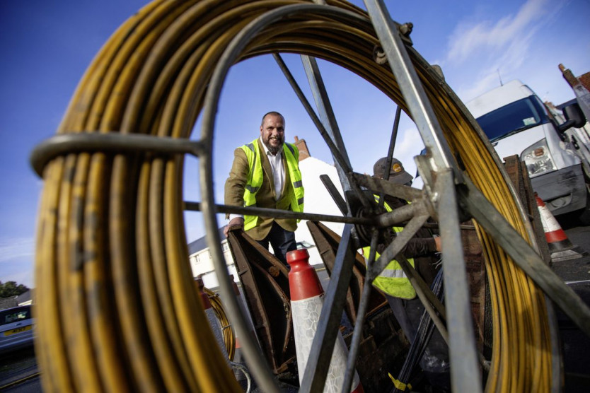Justin Bellinger behind Fibre cabling