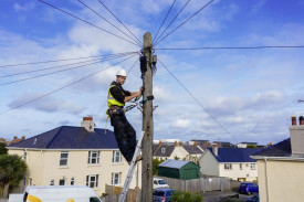 Scott Fuselier working on overhead cables
